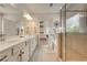 Bathroom showcasing double vanity, sleek lighting, and a glass-enclosed shower with tub at 122 Grove View Rd, Woodstock, GA 30189