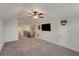 Spacious bonus room with a ceiling fan, television, access to the stairwell, and a closet for storage at 122 Grove View Rd, Woodstock, GA 30189