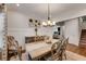 Elegant dining room with a stylish table, decorative chandelier, and wainscoting detail, perfect for hosting dinner parties at 122 Grove View Rd, Woodstock, GA 30189
