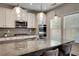 Modern kitchen featuring granite countertops, pendant lighting, and stainless steel appliances at 122 Grove View Rd, Woodstock, GA 30189