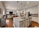 Bright and open kitchen layout featuring a large island with seating, stainless steel appliances, and seamless design at 122 Grove View Rd, Woodstock, GA 30189