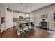 Kitchen island with stainless steel barstools, granite countertops, and modern pendant lighting fixtures at 122 Grove View Rd, Woodstock, GA 30189