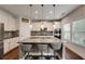Modern kitchen featuring a spacious granite island, stainless steel appliances, and sleek white cabinetry at 122 Grove View Rd, Woodstock, GA 30189