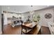 Open kitchen and dining area features modern lighting, stainless steel appliances, and seamless access to the outdoor patio at 122 Grove View Rd, Woodstock, GA 30189