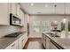 Bright kitchen with granite countertops, stainless-steel appliances, and ample cabinet space at 122 Grove View Rd, Woodstock, GA 30189
