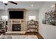 Inviting living room features a stone fireplace with mounted TV and built-in shelving for a cozy, modern space at 122 Grove View Rd, Woodstock, GA 30189