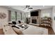 Cozy living room with a stone fireplace, plush sectional sofa, and built-in bookshelves, creating a welcoming space at 122 Grove View Rd, Woodstock, GA 30189