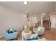 Open loft sitting area with 4 armchairs, round ottoman, and staircase leading to lower level at 122 Grove View Rd, Woodstock, GA 30189