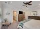 Bright main bedroom featuring light neutral tones, an ensuite, and a decorative ceiling fan at 122 Grove View Rd, Woodstock, GA 30189