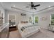 Main bedroom featuring a large bed, a decorative ceiling fan, and plenty of natural light at 122 Grove View Rd, Woodstock, GA 30189