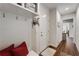 Hallway with a white mudroom bench with coat hooks, opening to the rest of the house at 122 Grove View Rd, Woodstock, GA 30189