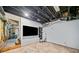 Finished basement with a dark-painted exposed ceiling and a large television at 3310 Southlake Ln, Cumming, GA 30041