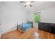 Bright bedroom with hardwood floors, a ceiling fan, and a window with natural light at 3310 Southlake Ln, Cumming, GA 30041