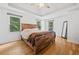 Brightly lit main bedroom boasts hardwood floors and plenty of natural light at 3310 Southlake Ln, Cumming, GA 30041
