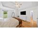 Brightly lit main bedroom boasts tray ceilings and hardwood floors at 3310 Southlake Ln, Cumming, GA 30041