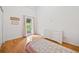 Airy bedroom featuring wood floors and access to an outdoor balcony at 3310 Southlake Ln, Cumming, GA 30041