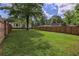 Spacious backyard with tall privacy fence and shade trees at 4067 Lenora Church Rd, Snellville, GA 30039