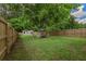 Large backyard with a tall privacy fence and mature landscaping at 4067 Lenora Church Rd, Snellville, GA 30039