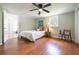 Comfortable bedroom with wood floors, ceiling fan, and a window at 4067 Lenora Church Rd, Snellville, GA 30039