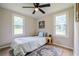 Bright bedroom with light walls, ceiling fan and two sunny windows at 4067 Lenora Church Rd, Snellville, GA 30039