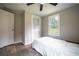 Bedroom features wood floors, ceiling fan and a bright window at 4067 Lenora Church Rd, Snellville, GA 30039