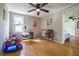 bedroom with hardwood flooring, ceiling fan, and bright window at 4067 Lenora Church Rd, Snellville, GA 30039
