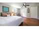 Cozy bedroom features wood floors, ceiling fan and a bright window at 4067 Lenora Church Rd, Snellville, GA 30039