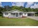Charming single-story home featuring a covered porch and carport on a sunny day at 4067 Lenora Church Rd, Snellville, GA 30039
