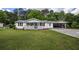 Charming single-story home featuring a covered porch, lush lawn, and a convenient carport at 4067 Lenora Church Rd, Snellville, GA 30039