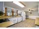 Bright kitchen with white cabinets and appliances, with a view to living area at 4067 Lenora Church Rd, Snellville, GA 30039