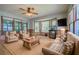 Cozy living room filled with natural light, comfortable seating, and wood paneling at 4067 Lenora Church Rd, Snellville, GA 30039