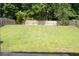 Expansive backyard with a lush, green lawn and privacy fencing, ideal for outdoor activities at 4450 Ivy Fork Dr, Loganville, GA 30052