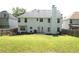 Backyard view of the home with a large, green lawn and a patio area at 4450 Ivy Fork Dr, Loganville, GA 30052