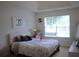 Bright bedroom with a large window, a bed, and neutral decor at 4450 Ivy Fork Dr, Loganville, GA 30052
