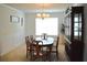 Traditional dining room with wood table, chairs, and display cabinet at 4450 Ivy Fork Dr, Loganville, GA 30052