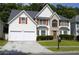 Charming two-story home with brick accents, a well-manicured lawn, and a two-car garage at 4450 Ivy Fork Dr, Loganville, GA 30052