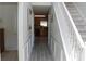 Hallway view leading to the kitchen, featuring wood-look floors and white wainscoting at 4450 Ivy Fork Dr, Loganville, GA 30052