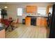 Bright kitchen with light wood cabinets, modern appliances, and dining area at 4450 Ivy Fork Dr, Loganville, GA 30052