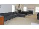Spacious living room with a grey sectional sofa, fireplace and bed at 4450 Ivy Fork Dr, Loganville, GA 30052