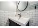Modern bathroom sink with tile back splash and mirror at 549 Atwood Sw St, Atlanta, GA 30310