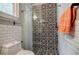 Stylish bathroom with patterned tile, white subway tile, glass shower door, and modern fixtures at 549 Atwood Sw St, Atlanta, GA 30310