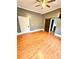 Spacious bedroom featuring a sliding barn door, ceiling fan, and gleaming hardwood floors at 549 Atwood Sw St, Atlanta, GA 30310