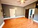 Spacious bedroom featuring a sliding barn door, ceiling fan, and gleaming hardwood floors at 549 Atwood Sw St, Atlanta, GA 30310