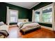 Sunlit bedroom with hardwood floors, large windows, and a comfortable bed at 549 Atwood Sw St, Atlanta, GA 30310