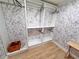 A well-organized closet with custom shelving and stylish wallpaper enhances storage at 549 Atwood Sw St, Atlanta, GA 30310