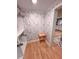 Stylish walk-in closet featuring wallpaper, wood floors, and a view of the kitchen at 549 Atwood Sw St, Atlanta, GA 30310
