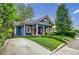 Attractive blue house with charming curb appeal, complemented by green lawn, driveway, and mature trees at 549 Atwood Sw St, Atlanta, GA 30310