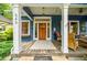Inviting front porch with seating area, wooden door, and decorative details create a cozy outdoor space at 549 Atwood Sw St, Atlanta, GA 30310