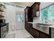 Modern kitchen featuring dark wood cabinets, stainless steel appliances, and hexagonal tile flooring at 549 Atwood Sw St, Atlanta, GA 30310