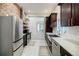 Modern kitchen featuring stainless steel appliances, dark cabinets, and white subway tile back splash at 549 Atwood Sw St, Atlanta, GA 30310